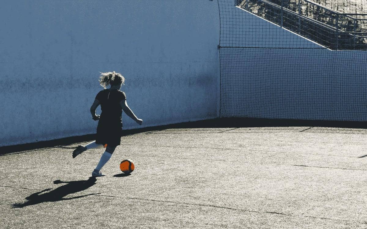 Women playing football on ground
